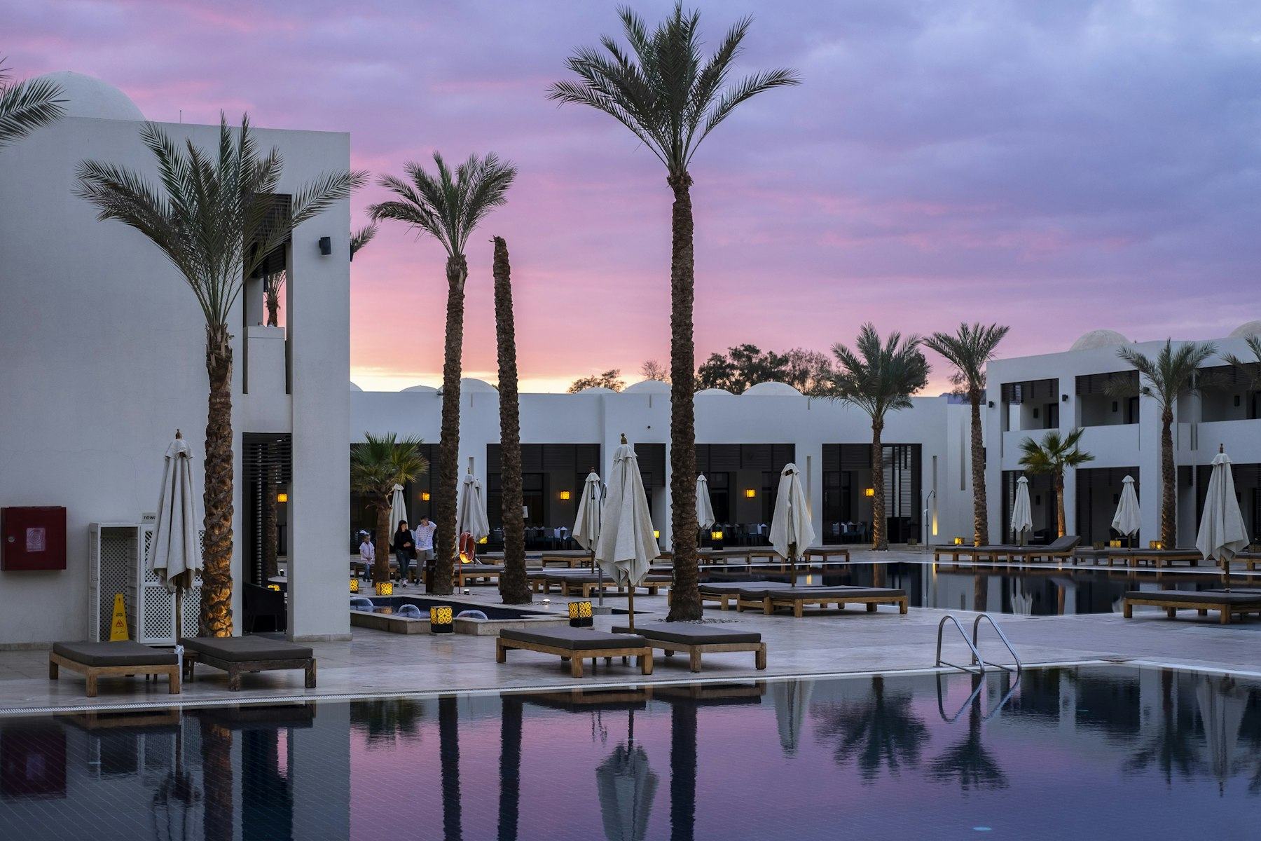 Resort pool loungers at sunset