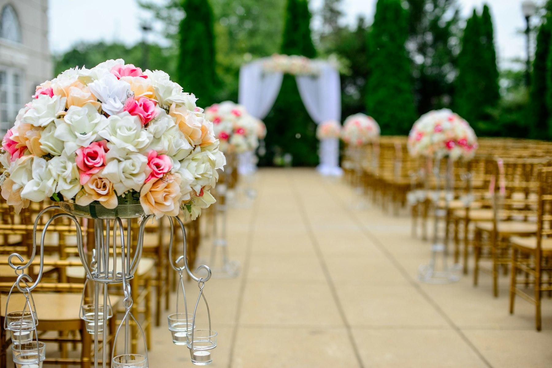 Outdoor wedding ceremony set-up with floral aisle